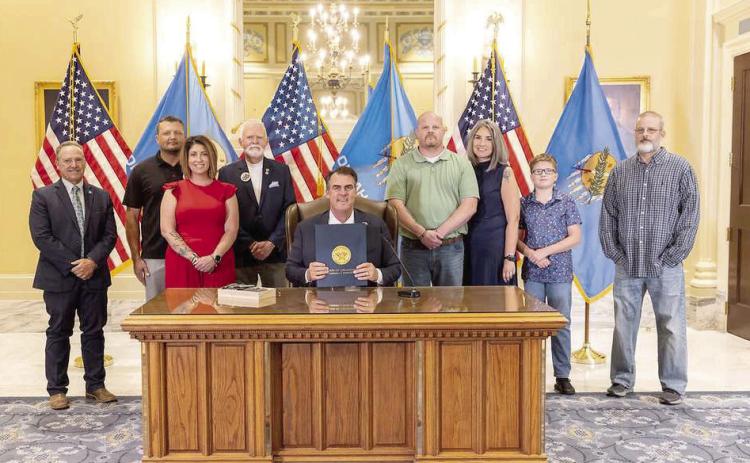 Pictured in no particular order are Rep. Danny Sterling, Walter Morris, Candi Morris, Rusty Bias, Gov. Kevin Stitt, Jace Bias, Kari Bias, Matt Bias, and Gary Wallis. Photo provided