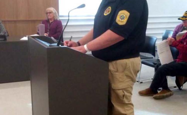 Sheriff’s Deputy Jared Strand reviews disposal requests with the County Commissioners. Countywide & Sun/Bill Rooth