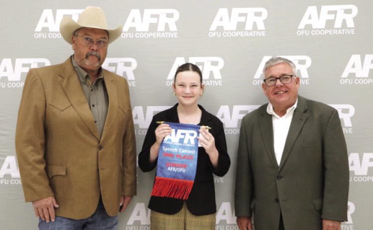 Bethel 4-H Member Taycie Baker poses with AFR Cooperative Vice President Toby Wallace, left, and AFR Cooperative President Scott Blubaugh after winning second place in the AFR Central District Speech Contest Junior Division on Nov. 10. Photo provided