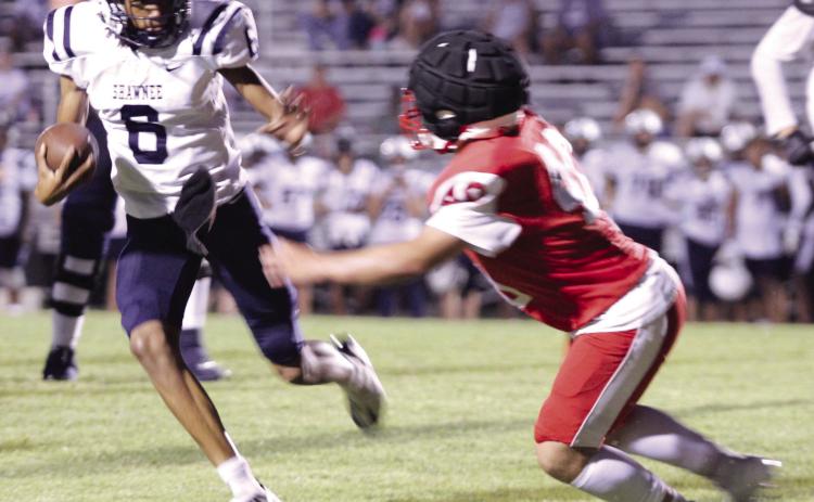 Shawnee junior Zyron Campbell deflects a McLoud defender for a first down and 20, but a call of holding made the Wolves lose yardage during the scrimmage at McLoud on Aug. 29. They played half a game, and the Redskins beat the Wolves, 19-14. Shawnee will play their first home game on Sept. 13 at 7 pm against Ardmore, and McLoud’s first home game will be Friday (Sept. 6) at 7 pm versus Harrah. Countywide & Sun/Natasha Dunagan