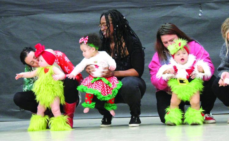 Girls in the 10-23-months division compete in the 28th Annual Christmas Miss &amp; Mister Pageant on Dec. 3 at Will Rogers Elementary in Shawnee. Assisted by their mothers, they are Hattie Jo Yount, Emberlynn Gallow, Mia Vernor, Jasper Valencia and Quinnley Fleming. Countywide &amp; Sun/Natasha Dunagan