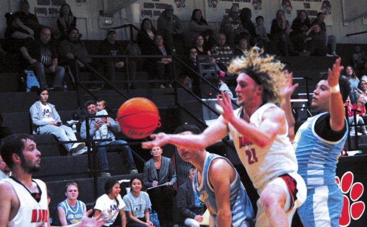 Above, Dylan Armstrong (#21) sets up his teammate Rodney Ray (#23) for a basket during Maud’s 62-47 win over New Lima, Feb. 8. Below, Lady Tigers’ Janlee impson (#13) leaps into the air in preparation to nail a two-pointer during Maud’s Feb. 8 home game versus New Lima. Countywide &amp; Sun/Kendra Johnson