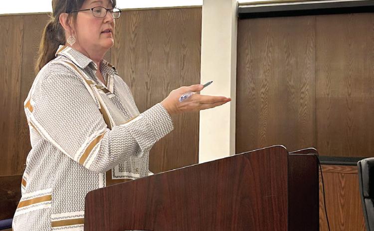 Stacey Bateman-Woods, Attorney for the Pottawatomie County Commissioners, addresses the SCCDA Board regarding the contract to transfer IFYR intellectual property to the County. Suzie Campbell, Countywide &amp; Sun