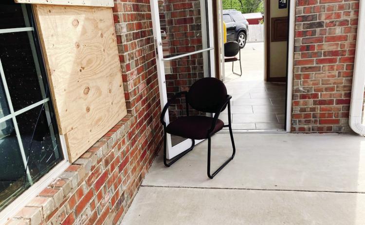 Joseph Armenta gripped the metal handle of the glass entry to Farmers Insurance on the corner of Federal and Kickapoo, while the April 19 tornado continued its path of destruction in Shawnee. Photo provided by Armento.