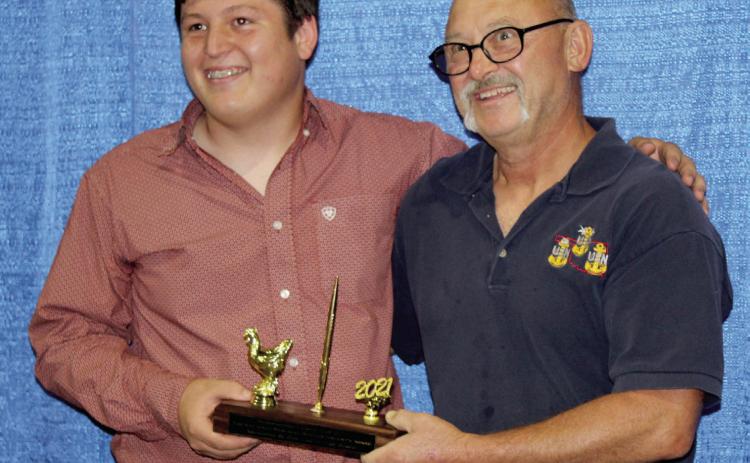 Bethel graduate Michael St. Clair presents Jimmy Story with the Kay Jenks Memorial Superintendent’s Award for being an outstanding volunteer in the poultry division in 2021. File photo.