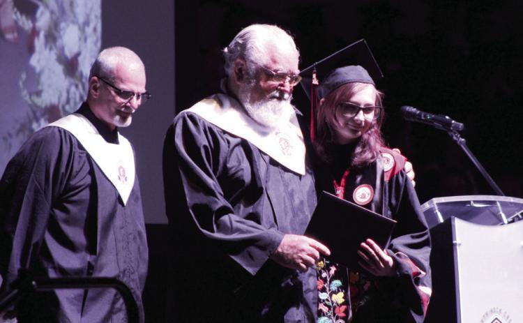 Aaliyah Coffman receives her diploma from her father, North Rock Creek Board of Education Member Brian Blansett, during graduation on May 22. NRC High School graduated 112 seniors. Natasha Dunagan, Countywide &amp; Sun