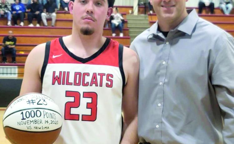 Earlsboro senior Danney Billingsley poses with Coach Chad Rochelle and the game ball after joining the 1,000-Point Club at New Lima on Nov. 14. Photo provided