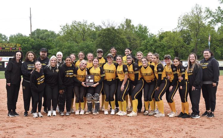 The Tecumseh Lady Savages Slow Pitch Team, along with their coaches, managers and athletic director, pose after winning their Class 5A Slow Pitch District Tournament at home. On April 22, they beat Harding Charter, 23-0, and Purcell, 11-1. Then, on April 23, they beat Purcell again, 13-0. Photo courtesy of Kenetta Lisenbee