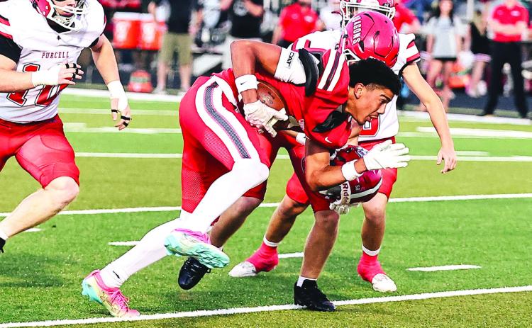 North Rock Creek's Tyson Hawkins gets his helmet ripped off during his run in the Purcell match-up on Oct. 9.