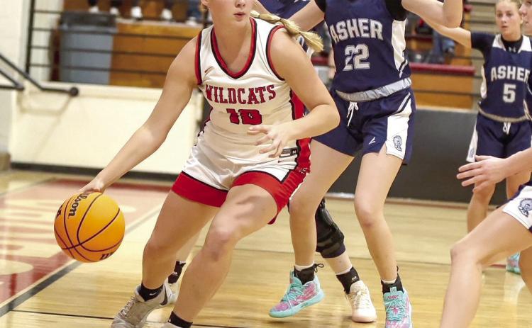 Earlsboro freshmen Peighton Worley drives around Asher.