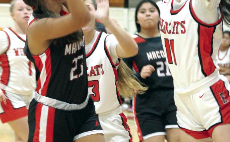 Macomb sophomore McKenzie Brummett aims for the basket, as Earlsboro junior Natalie Peters (#11) plays defense, in the Earlsboro home game on Dec. 12. The Lady Wildcats won, 40-37, and the Wildcats also beat the Hornets, 78-32, that night.