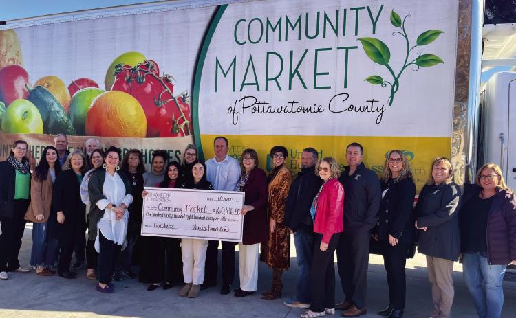 Board Members &amp; Staff from Community Market and Avedis Foundation together with Daniel Matthews, Executive Director CMPC (center, white shirt) and Kathy Laster, Ph. D., MBA President &amp; CEO Avedis Foundation (on Matthews left, holding the end of the check). Photo provided