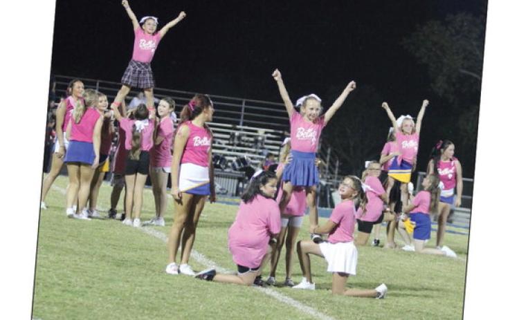 Third- through fifth- grade girls, who went to the Bethel Cheer Clinic last week, form pyramids during halftime of the Oct. 4 Bethel home game. The pre-K through second-grade group, led by the Bethel High School Cheerleaders, also performed that night. Countywide & Sun/ Natasha Dunagan