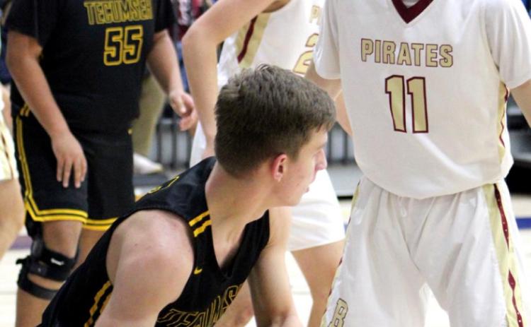 Tecumseh’s Brady Overstreet looks to pass around a Byng defender during the First United Bank Classic consolation championship round in Bethel on Dec. 11.