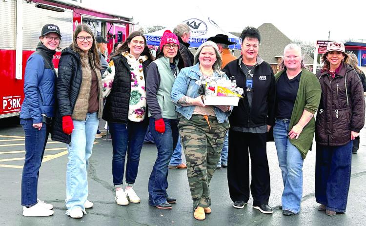 A gift basket filled with items from local businesses was given to the Oklahoma Pork Council by the Tecumseh Chamber of Commerce to thank the council for choosing Tecumseh as one of seven sites for a Free Pork Lunch event with 300 meals available on Dec. 16. Shown, from left, are four representatives of the OPC, Incoming Chamber President Cama Watts, Gilbert Insurance Owner Suzanne Gilbert, Chamber Executive Director Kim Elliott and OPC Executive Director Kylee Deniz. Suzie Campbell, Countywide & Sun