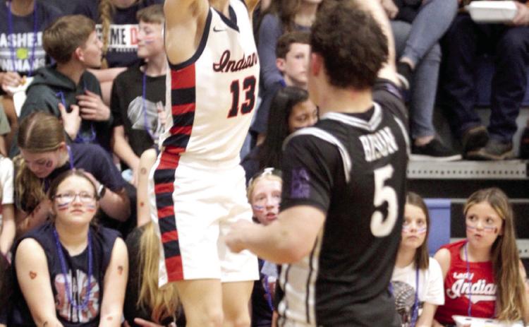 Asher's Pierce Aduddell sinks a trey in the Feb. 13 District home game against the Oklahoma School for the Deaf. The Indians won, 62-38, and advanced to Regionals at Maud on Tues., Feb. 17. The Lady Indians also won their District game that night and would play in Regionals.