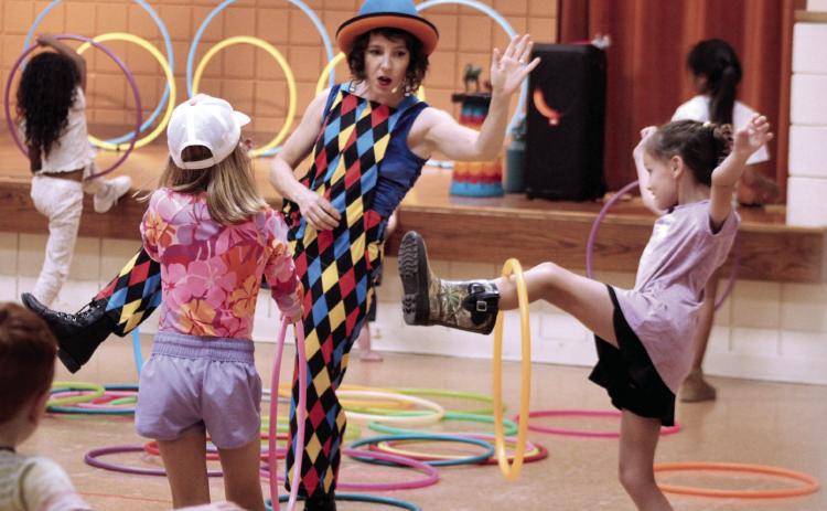 Chelsea Parks, aka "Hooplahoma," demonstrates how to spin a small hula hoop on your leg during the Tecumseh Public Library program on June 25. Photos by Natasha Dunagan, Countywide & Sun