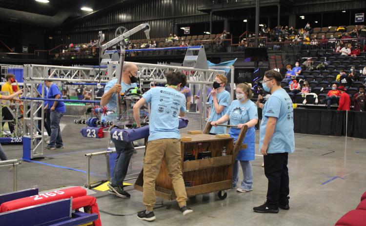 The Sprockets load up their robot.