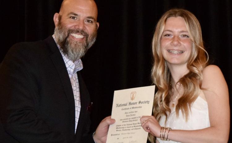 SHS Principal Matt Johnson presents an NHS certificate to junior Anna Jordan.