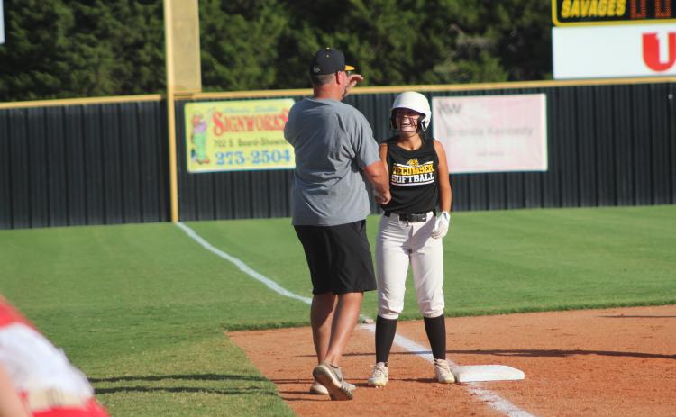 Tecumseh’s Taylor Gage shakes hands with Coach Chad Trahan at third base after hitting a triple during the home game against McLoud, Sept. 19. Countywide & Sun/Natasha Dunagan