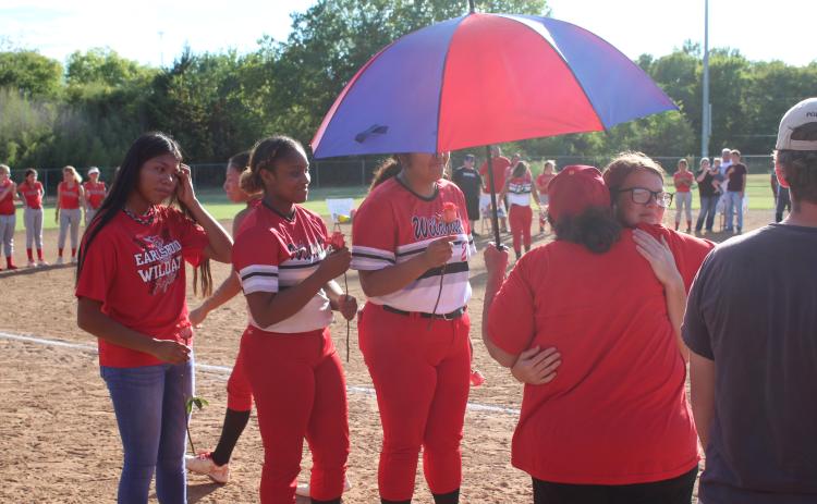 Earlsboro's Fastpitch Team "Grandma" Amelia Streater gets a hug from senior Jamie Smith during Senior Night, as Smith's teammates wait to give hugs, as well, on Sept. 20. Streater is the actual grandmother of senior Sierra Streater, and said, "I love my babies." Countywide & Sun/Natasha Dunagan