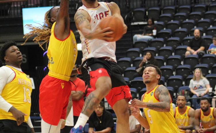 The MVP of the TBL, DeShawn Munson, goes in for a basket during the FireLake Arena Fall Shootout Basketball Tournament on Oct. 15. Munson was playing on the "Shawnee Fire" team against "New Era," and there were seven teams total in the pro-am tournament held at FireLake Arena and the Shawnee YMCA. The Fire won first in the tournament. Countywide & Sun/Natasha Dunagan