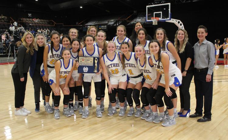 The Bethel Lady Wildcats and their coaches pose with their Bethel First United Basketball Tournament Champion Trophy on Dec. 10 at FireLake Arena. Over the three-day event, the Lady Wildcats won all three of their games, beating U.S. Grant, 63-19, Byng, 56-41, and Tecumseh, 63-33, to take the girls side of the tournament. Countywide & Sun/Natasha Dunagan