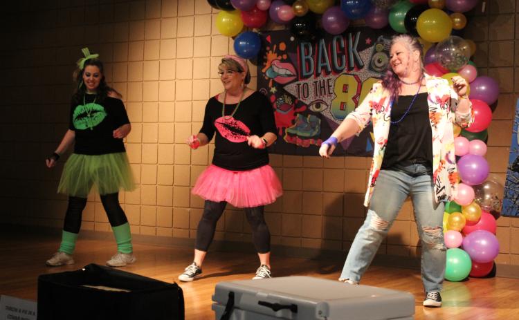 Tecumseh Chamber of Commerce Event Chair Becky Webb, Board President Kellie Clay, and Executive Director Kimberly Elliott dance to “Footloose” during the Annual Auction on Feb. 23. The theme for the event was “Back to the 80s.”