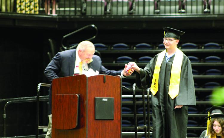 Tecumseh High School Principal Randy Dilbeck gets a can of Dr. Pepper from graduate Tallon Formanski, as he did from all of the 143 graduates, at graduation on May 17. Countywide & Sun/Natasha Dunagan