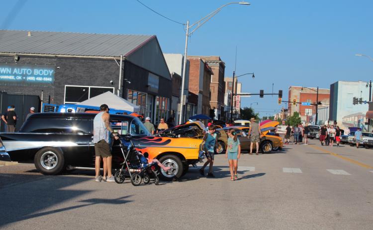 People of all ages enjoy the Downtown at Sundown Car Show on Main Street in Shawnee on July 15. The fourth annual event presented by Downtown Auto Body and DTAB Customs included around 300 cars and trucks, live music by Nasty Weather, games, giveaways, and food trucks. Countywide & Sun/Natasha Dunagan