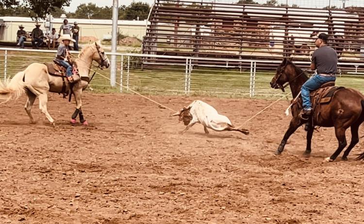 Ransom Parsons, 7, and his father Montana Parsons of Earlsboro work together to rope a steer during the COJRA rodeo in Perry, OK, on July 15. Ransom's mother, Shelby Parsons, said he won first in the 10-13 Heading division both days of the rodeo. Photo provided.