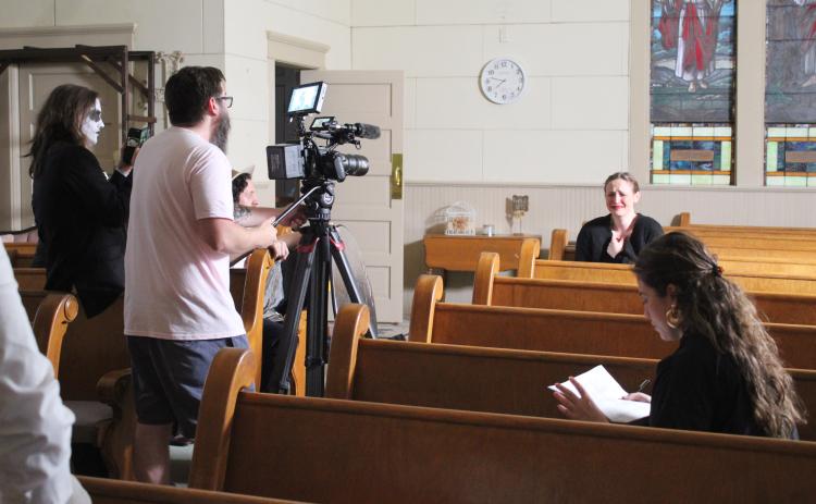 Dead End Film House Director Jeff Richardson records as actress Grace Black, background, goes through “sadness” for the short, silent film, “Seance.” Black was acting out each of the emotions. The OKC-based company was filming at the Broadway Chapel in Tecumseh on Sept. 8, after finding the location through venue owner Dennis Dyer. Also shown is actor, Jordy Branam, far left. Countywide & Sun/Natasha Dunagan