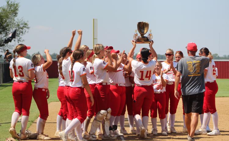 The Dale Lady Pirates celebrate after winning the Dale-Tecumseh Tournament on Sept. 9.