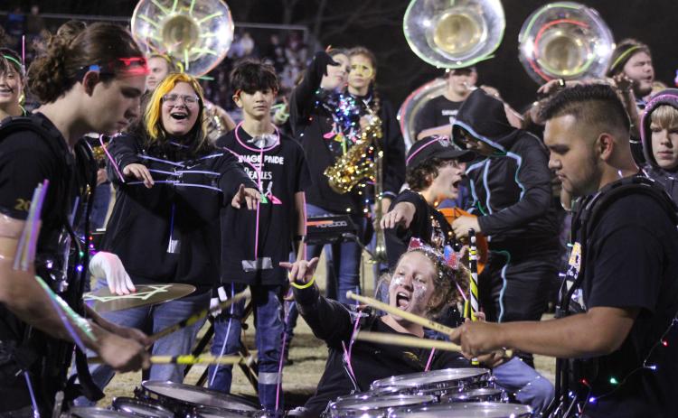 Tecumseh drummer Laycee Thoma cheers on fellow drummers Dalton Lewelling and Alan Lopez-Moreno, along with the rest of the band, following the annual light show at halftime of the Nov. 3 home game. Countywide & Sun/Natasha Dunagan