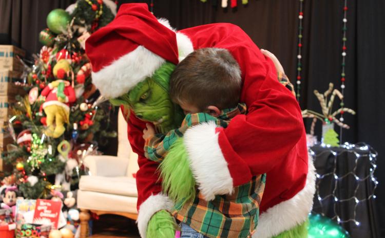 Princetyn Mack, 5, of Shawnee, gets a hug from the Grinch  at the Grinchmas Whoville event, held in the Tecumseh City Hall Auditorium on Nov. 30. Countywide & Sun/Natasha Dunagan