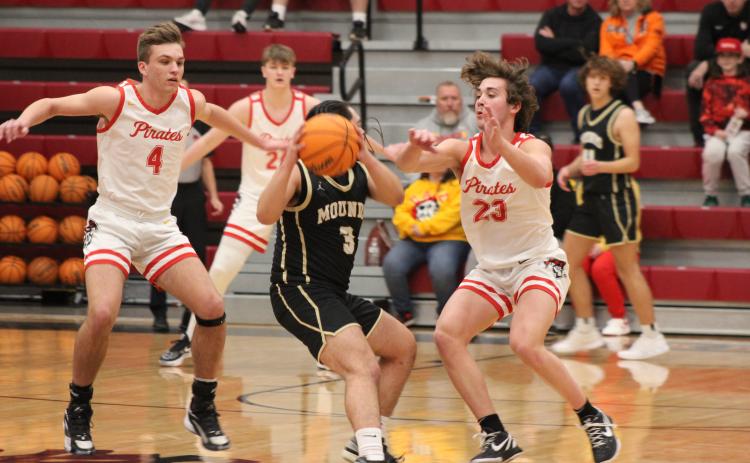 Dale's Jett Higdon (#4), Tray Chambers (#24), and Deken Jones (#23) defend the hoop during the Class 2A District game with Mounds, Feb. 17. The Pirates stomped Mounds, 90-37, and will play in regional competition at Dale today (Feb. 22) at 7:30 pm.  Countywide & Sun/Natasha Dunagan