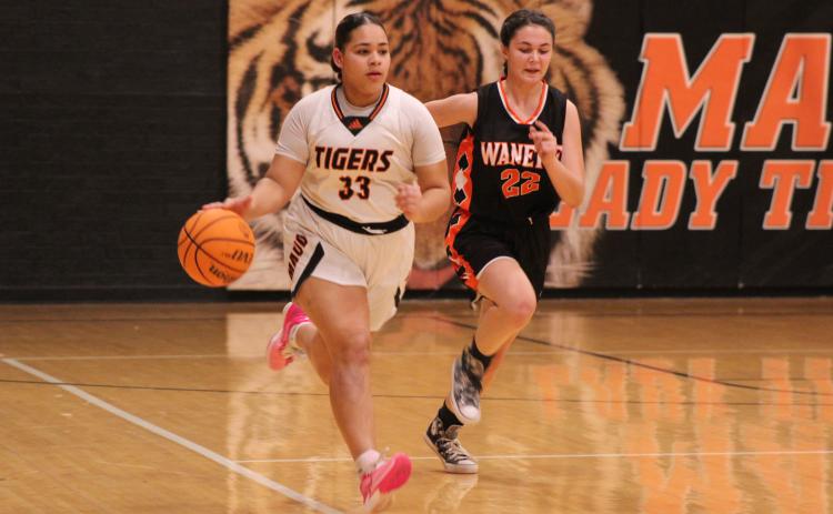 Maud’s Amerikus Street takes the ball up the court followed by Wanette’s Cala Tankslay in the third quarter of the Jan. 26 homecoming game.