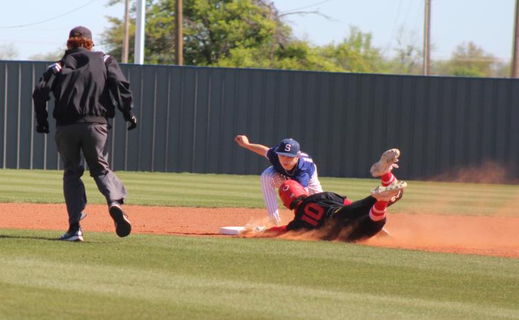 Shawnee sophomore Dominic Denega tags Dale's Braylon White as he dives into second during the Bill Tipton Classic game at Shawnee on April 11. The Dale Pirates won all four of their games, as well as the tournament. They beat Shawnee, 9-6; Eisenhower, 6-0; Piedmont, 7-3; and Elgin, 14-6, over three days. Countywide & Sun/Natasha Dunagan