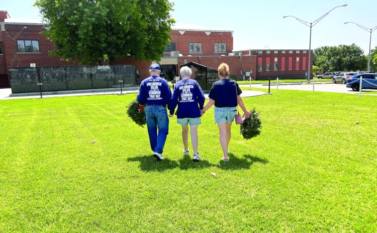 David and Linda Hendrickson and Donna Beth Warren walk in unity to the Gold Star monument at Woodland Veterans Park in Shawnee. The morning was filled with a lot of emotion from the families and those who attended the service. Countywide & Sun/Suzie Campbell
