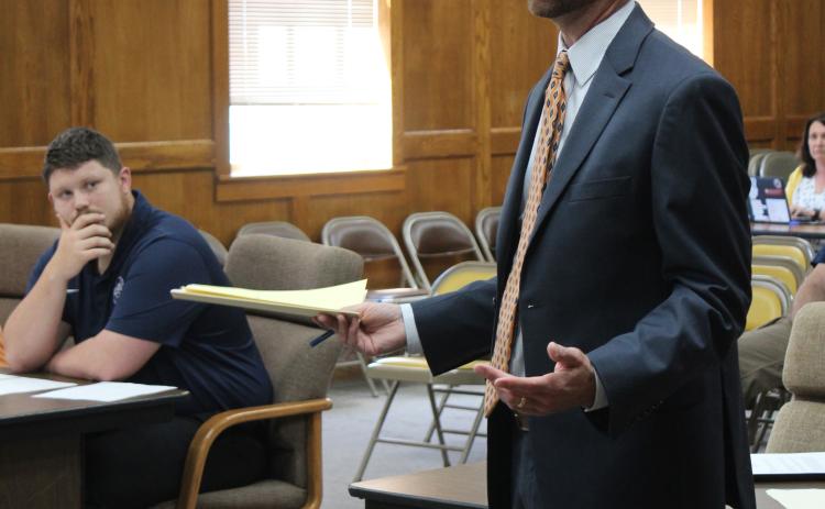Jordan Smith with Stephen L. Smith Corp. speaks to the Shawnee Board of Education before reading bank bids for a construction bond sale.