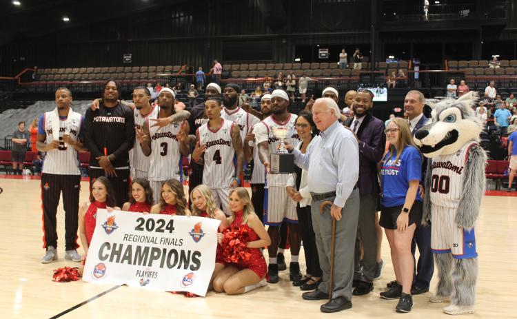 The Potawatomi Fire team - along with Head Coach Mark Dannhoff and Assistant Coach Emmanuel Toney, Athletic Trainer Taylor Williams, the Fire Girls, and Citizen Potawatomi Nation Chairman John "Rocky" Barrett and Vice Chair Linda Capps - pose with the 2024 TBL Regional Finals Champions banner and trophy on June 15. They won the second western regional game against the Los Angeles Ignite, 120-96, making this their 26th straight win this season, according to potawatomifire.com.