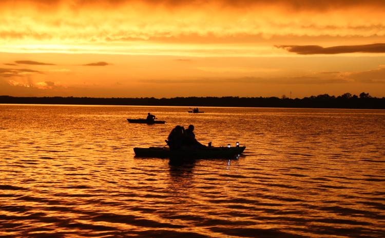 The sun sets over Shawnee Twin Lake #2 during the Fifth Annual Pott. County Kayak Club 4th of July Glow Paddle, just before a rainy evening. The group just recently reached 2,000 members on its Facebook page, and has been growing since its formation in Sept. 2019. Countywide & Sun/Natasha Dunagan