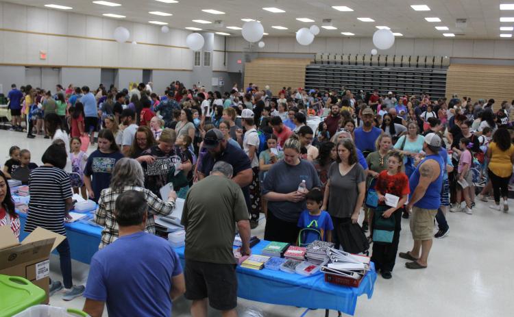 Families and students fill the WP Wood/THS Alumni Center waiting in line at eight stations for school supplies and backpacks on July 27 during the 10th Annual Mission Tecumseh Back to School Bash. Mission Tecumseh Board Member Anthony LaGrange said they gave away the 549 backpacks they had available in the first hour and continued to hand out school supplies until those ran out. Countywide & Sun/ Natasha Dunagan