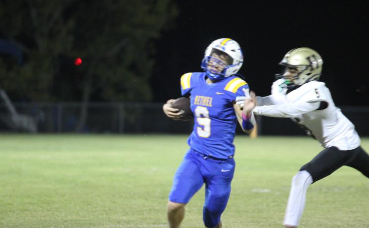 Bethel sophomore Maddox Davis tries to dodge being tackled while carrying the ball at the Oct. 4 home game with Hugo. The Wildcats lost, 24-38. Countywide & Sun/Natasha Dunagan