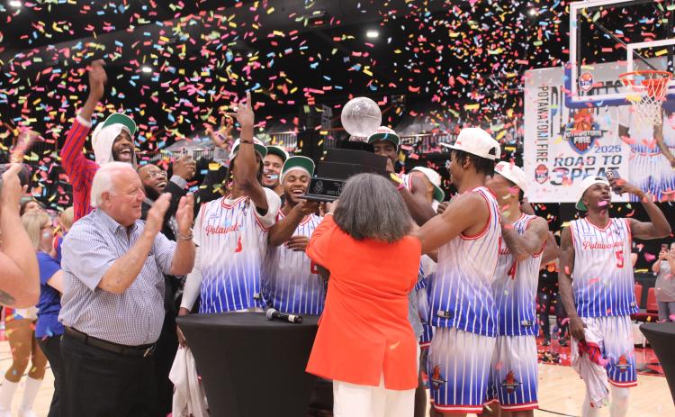 The Potawatomi Fire Team, along with Citizen Potawatomi Nation Chairman John 'Rocky' Barrett, The Basketball League CEO Evelyn Magley (back to camera) and Lillie Mae Greer (hidden by her daughter), celebrate their Three-Peat by lifting 'The Lillie' TBL 2025 Champion trophy high, amid confetti on June 23 at FireLake Arena. This is the third year in a row they have won this national title, the first in the TBL to do so. Their record for the season is 27-1, and 8-0 for the playoffs.