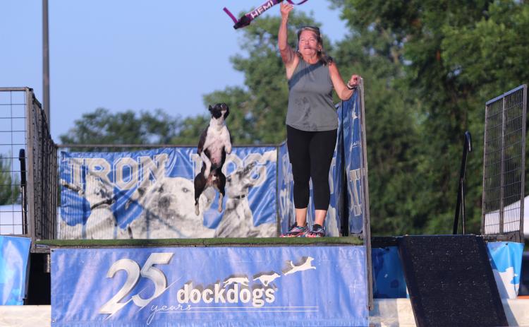Helena Cudd throws a toy for Hemi during the DockDogs® competition at the FireLake Fireflight Balloon Festival on Aug. 9. Hemi won first in the Pro Finals with a 25-foot, seven-inch jump. This is the first year for the competition, which attracted contestants from all over Oklahoma and Texas.