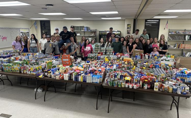 Tecumseh FFA members pose after collecting a record-breaking 3,736 items in one hour from the community during their Food Drive Scavenger Hunt on Nov. 13. The non-perishable food was distributed  between the Highland Church of Christ Food Pantry and Tecumseh School Food Pantry. Photo provided.