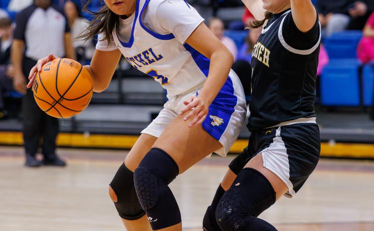 Bethel senior Alexis Tucker maneuvers around Tecumseh senior Cadence Leba during the Dec. 11 game in the Bethel First United Basketball Classic. The Lady Wildcats won this game, 49-36; beat Pauls Valley, 42-39; then fell to McLoud, 41-63, to take second in the three-day tournament. Photo courtesy of Richelle Treece.