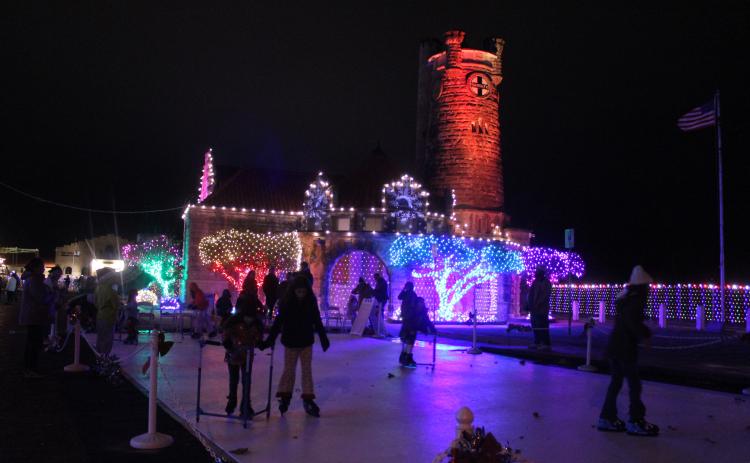 Several children and teens enjoy the ice-skating rink made of synthetic ice in front of the Santa Fe Depot in Shawnee during the Safe Events for Families "Winter Wonderland" on Nov. 28. Oklahoma Representative Dell Kerbs, with SEFF, said they had about 1,000 visitors to the free event in their opening weekend. Kerbs added that ice skates are available for those who need to borrow them. See full cutline below.