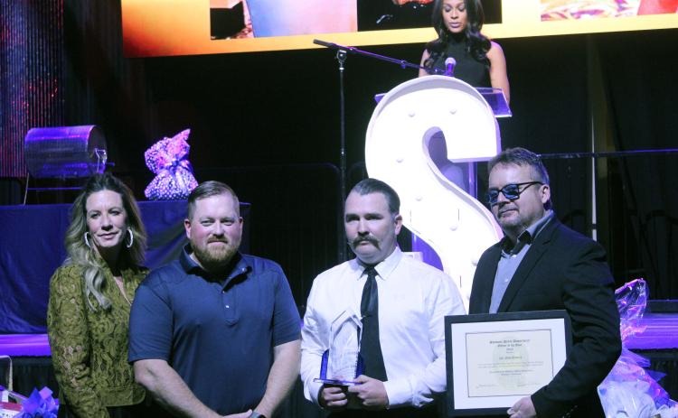Corporal Josh Soward, third from left, accepts the 2025 Officer of the Year Award Jan. 30 presented by Shawnee Police Foundation Chairman Melissa Stuteville, 2024 Officer of the Year Dennis Rains, and Shawnee Police Chief Mason Wilson. KOCO Channel 5 News Anchor Kylie Walker, on stage, was the emcee for the evening. Natasha Dunagan, Countywide & Sun